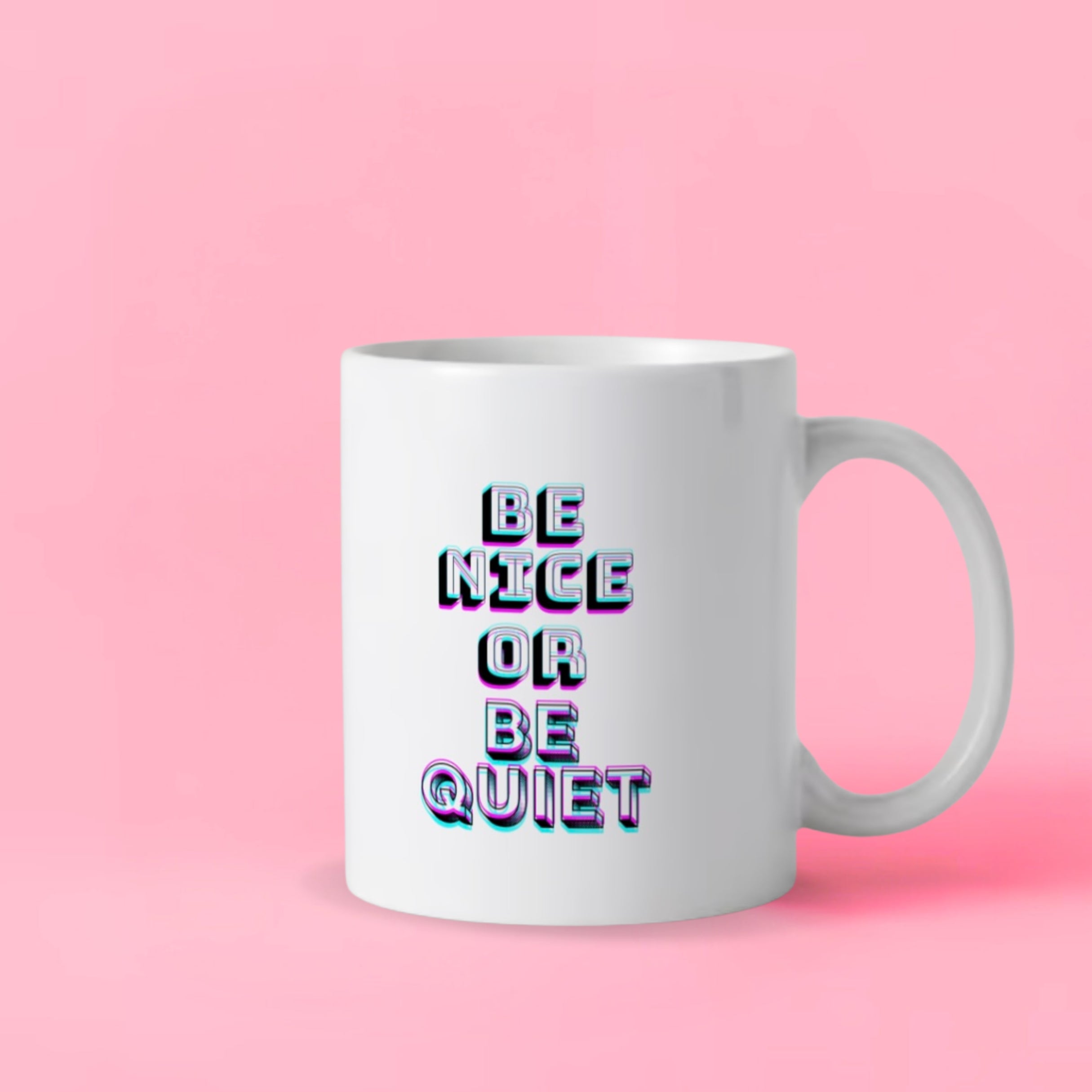 A white ceramic mug that says: 'Be Nice or Be Quiet.' 